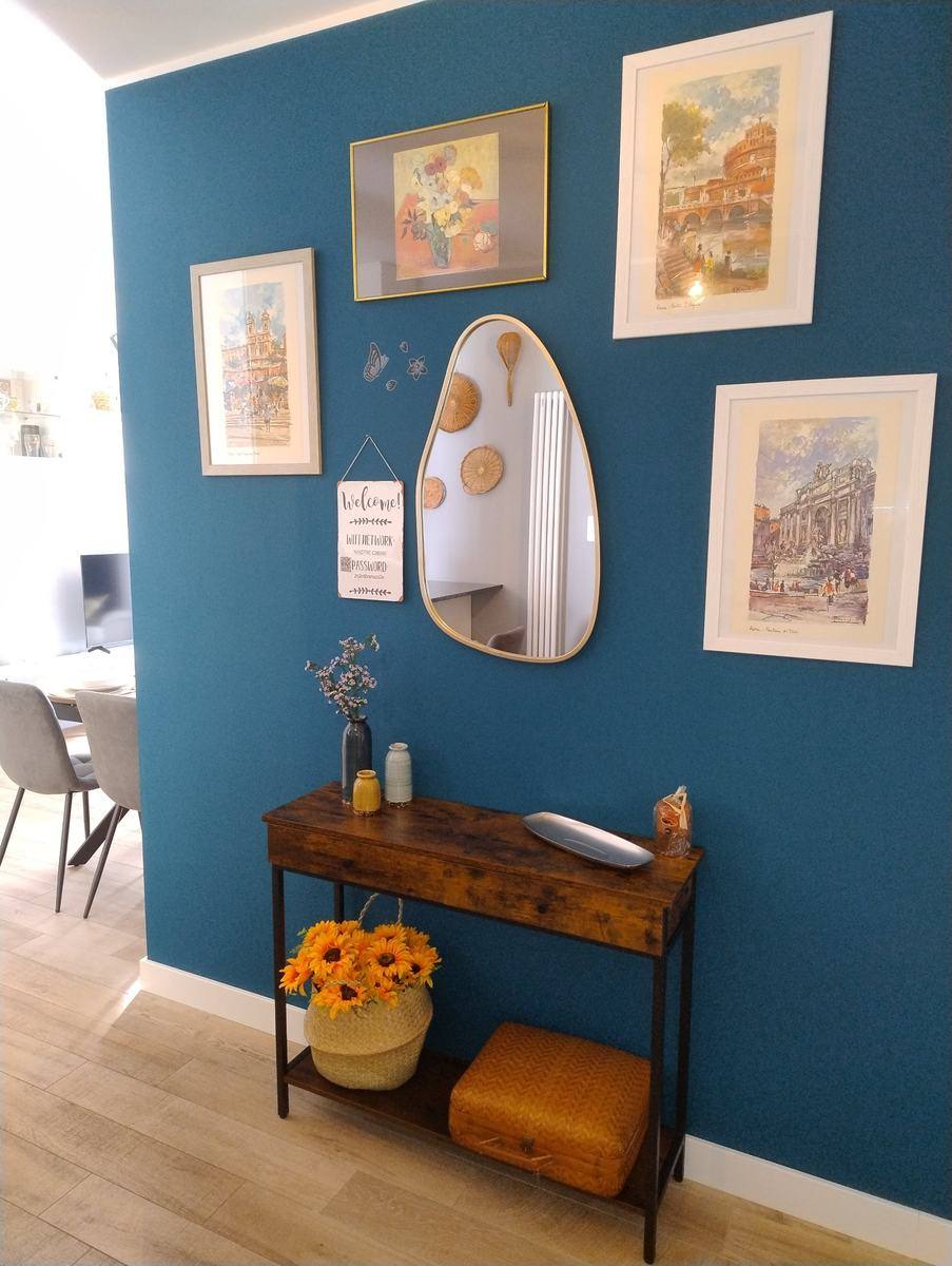 Entrance with blue wall and prints of Rome